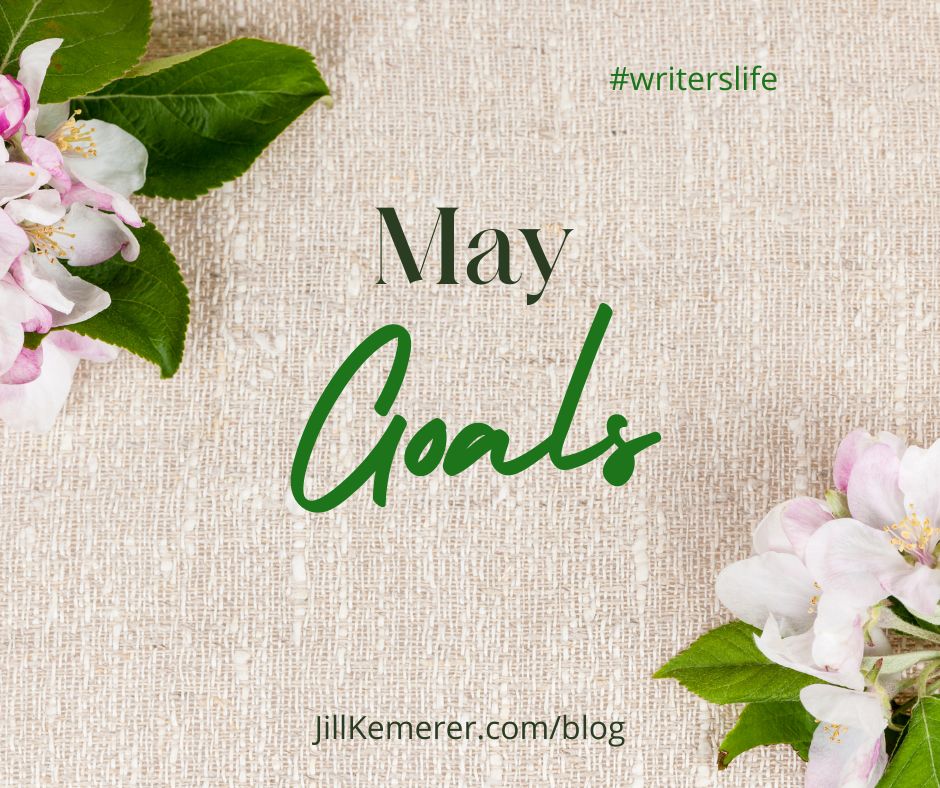 Linen background with two apple blossoms. Text "May Goals. Jillkemerer.com/blog. #writerslife"