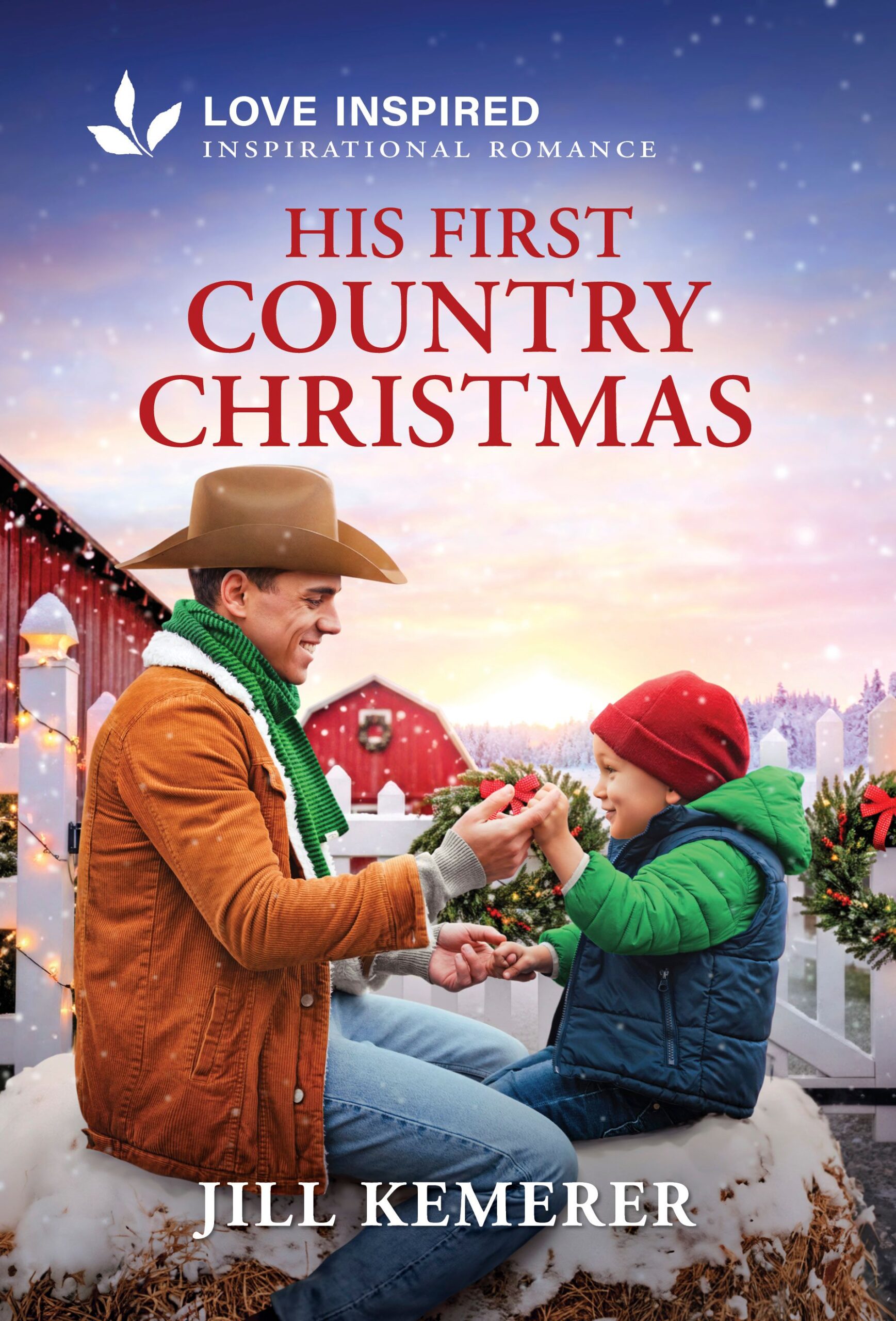 His First Country Christmas by Jill Kemerer cover. Cowboy sitting on snow-covered hay bale with little boy. White fence and red barn in the background with snow falling